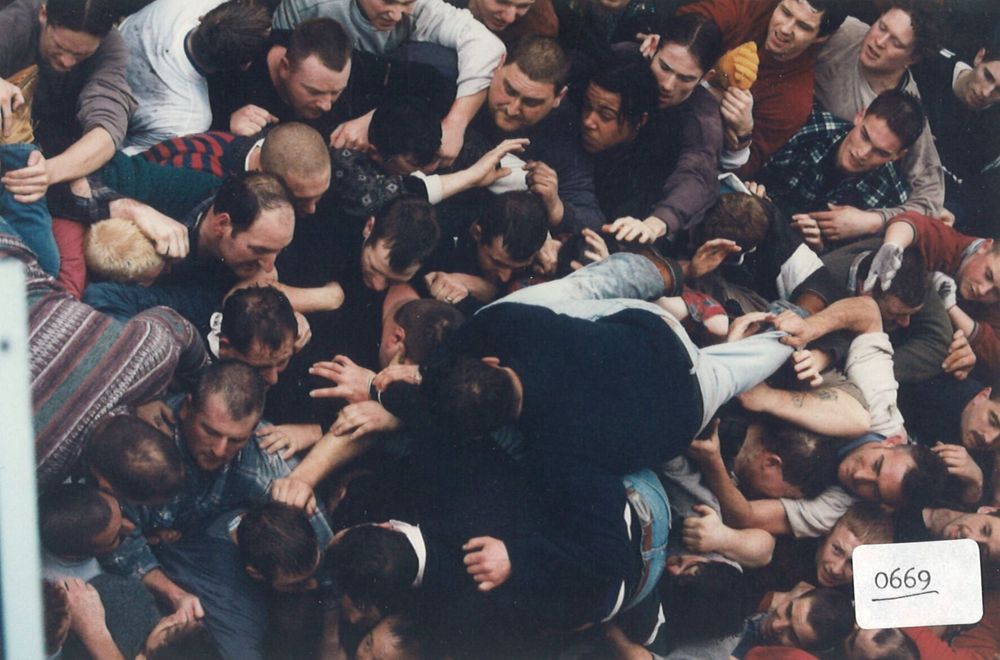 Photo of a melee of people wrestling in the street