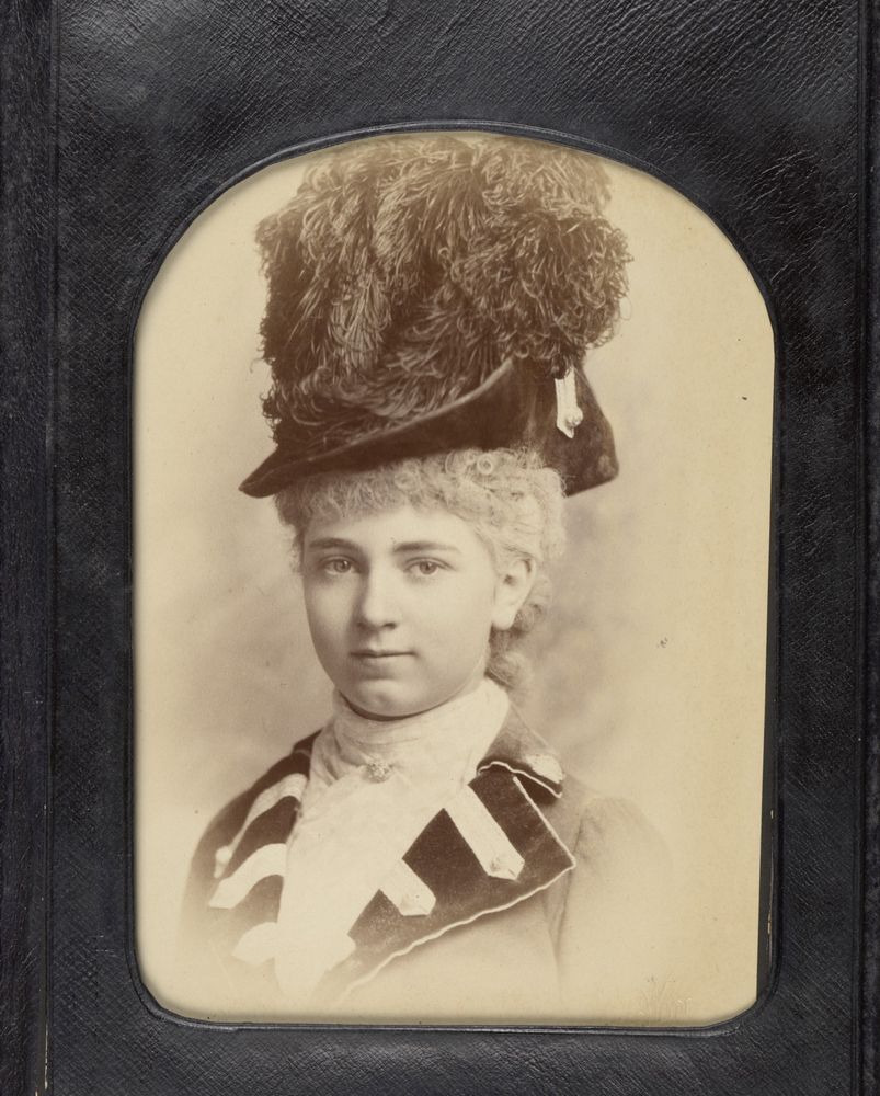 Sepia portrait of a young Frances Wolseley wearing a large, feathery hat and ruffled collar.